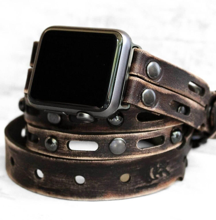 Distressed vintage brown leather apple watch wrap band showing weathered patina and triple wrap design. Distressed vintage brown leather apple watch wrap band showing weathered patina and triple wrap design.