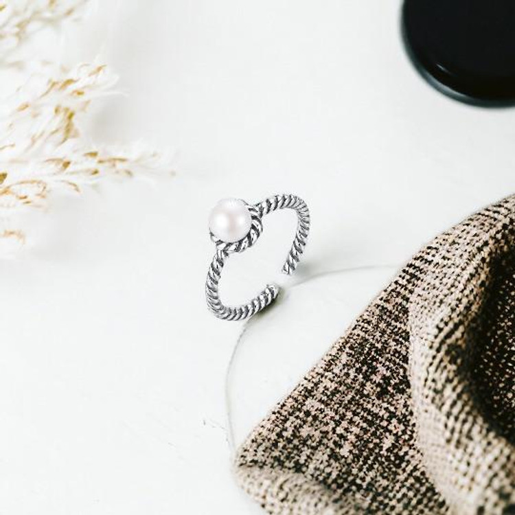 Silver-plated adjustable ring with white pearl and twisted rope band design.