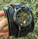 Black steampunk leather cuff watch for men shown outdoors
