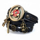 Angled view of dark leather steampunk wrap watch with a red and brass-tone watch cover, vintage gear decorations, windmill charm, and miniature lantern.