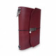 Handmade burgundy leather journal with curved flap, black elastic closure, and silver-tone accents