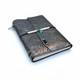 Handmade refillable leather journal with metallic floral pattern, wraparound flap, black elastic closure, and turquoise-colored accent.