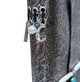 Close-up of metallic floral leather journal with silver-tone crescent moon, pearl bead, and Follow Your Bliss charms.