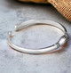 Holding Hands Silver Bangle