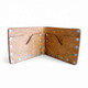 Open tan leather bifold wallet showing Western floral tooling across both interior panels and silver-tone metal rivets.