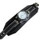 Black 2.5-inch wide leather cuff watch with white battery-operated quartz face and contrast stitching, sized for 8" wrist. Black 2.5-inch wide leather cuff watch with white battery-operated quartz face and contrast stitching, sized for 8" wrist.