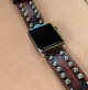Close-up of antique silver dome studs on rustic brown leather Apple Watch band for men Close-up of antique silver dome studs on rustic brown leather Apple Watch band for men