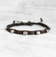 Adjustable brown leather bracelet with braided cord and beads