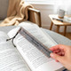 Leather bookmark shown in use inside a book