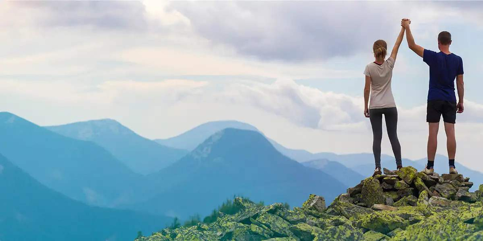 Couple Holding Hands On Mountain