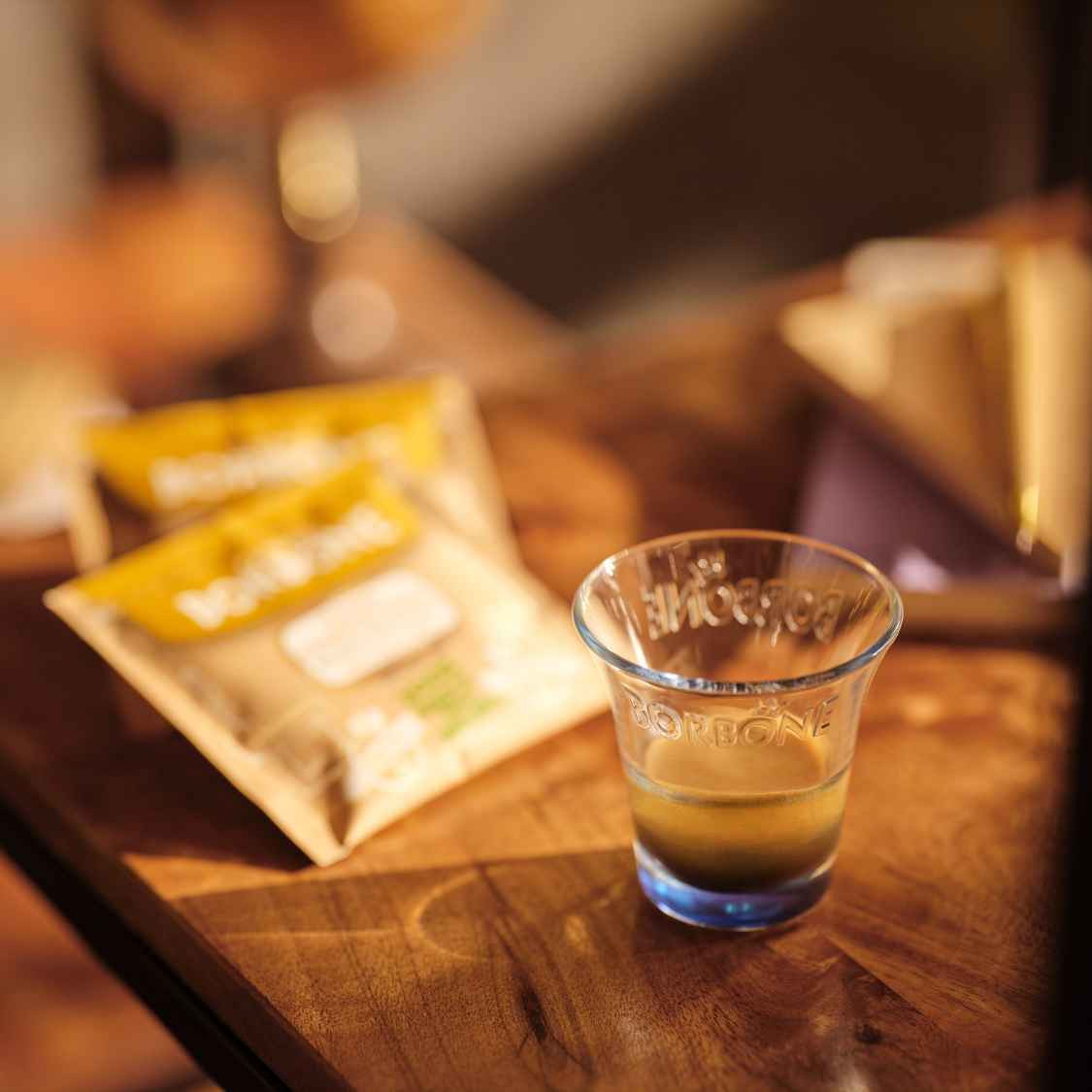 Lifestyle photo of Miscela Oro Caffe Borbone Espresso Pods with a shot of Italian espresso in an Italian espresso cup. - mobile gallery view