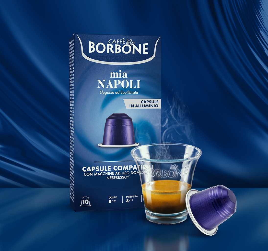 Caffe Borbone Mia Napoli - Aluminum Nespresso®* Machine Compatible Capsules, shown with a box of capsules, a cup of espresso, and one capsule outside the box against a blue background.