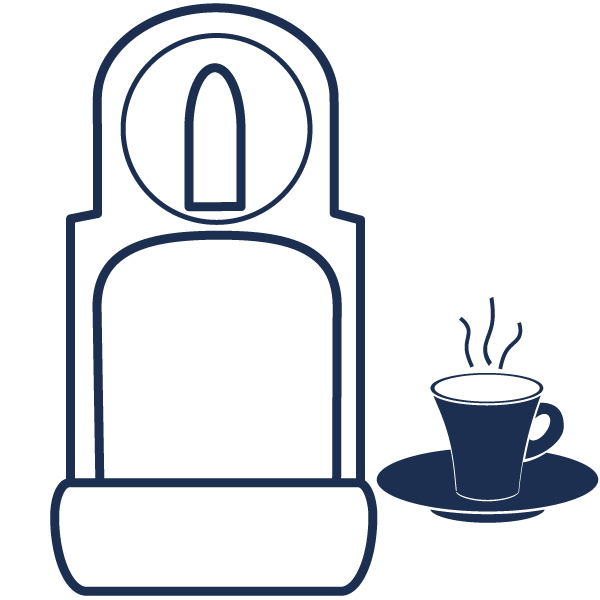 a cup of coffee on a plate next to a coffee machine