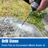 Bad Dog multipurpose drill bit boring into large outdoor stone with visible dust from drilling high-hardness material