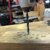 Sheet metal bit driving clean hole through wood board