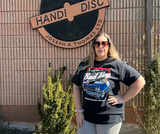 Woman wearing vintage car Bad Dog tee outside Handi Disc building Woman wearing vintage car Bad Dog tee outside Handi Disc building
