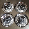 1 Set of 4 used C5053W Dodge Lancer 14 inch Hubcaps.