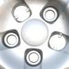 Close-up shows that just like the factory original hubcap, these wheel covers have two larger lug nut holes that have grabbing clips that grip the lug nuts. And the remaining three smaller holes are for screwing in the removed lug nuts and torquing them down to manufacturers specs, bolting the wheel cover to the wheel.  Close-up shows that just like the factory original hubcap, these wheel covers have two larger lug nut holes that have grabbing clips that grip the lug nuts. And the remaining three smaller holes are for screwing in the removed lug nuts and torquing them down to manufacturers specs, bolting the wheel cover to the wheel.