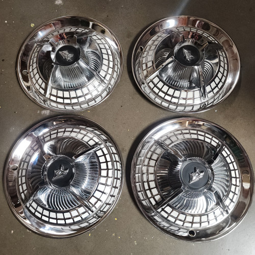1 Set of 4 used C5053W Dodge Lancer 14 inch Hubcaps.