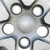Dodge Caravan hubcap Close-up of  lug nut holes shows two holes are slightly bigger allowing the not-removed lug nuts to fit through, and the other holes have a smaller diameter, so the lug nuts tighten down on the hubcap to hold it securely on the wheel.