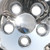 Close-up shows that just like the  Honda Civic factory hubcap, these are bolt-on caps that have two large lug nut holes and three smaller ones, so that you can replace the wheel cover without having to jack-up your car.