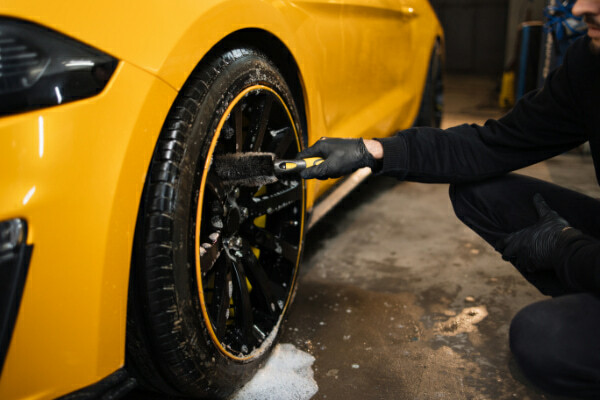 Soft bristle brush cleaning an aftermarket wheel