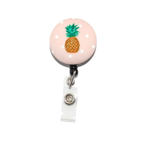 this is a picture of a pineapple id badge reel on pink mylar this is a picture of a pineapple id badge reel on pink mylar