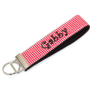 this is a picture of a red gingham fabric keychain this is a picture of a red gingham fabric keychain