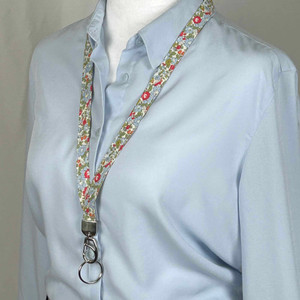 colorful red and blue floral fabric lanyard on mannequin facing forward colorful red and blue floral fabric lanyard on mannequin facing forward