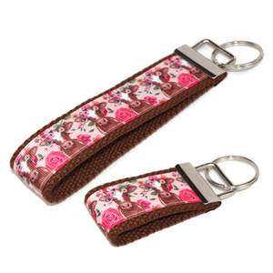brown cow with flowers keychain silver hardware in both wristlet and mini size brown cow with flowers keychain silver hardware in both wristlet and mini size