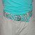 mint and turquoise floral fabric belt on a mannequin front view mint and turquoise floral fabric belt on a mannequin front view