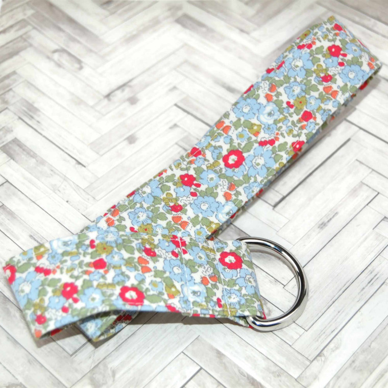colorful blue floral fabric belt up close on wood background