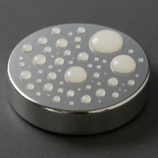 Visual example of low surface energy material showing poor adhesive wetting and bead formation