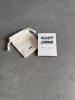 Sterling silver cloud earrings on a 'Silver Lining' message card. The earrings are shown with a Wue gift bag.