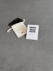 Sterling silver whale tail earrings on a 'Whale Hello There' message card. The earrings are shown with a Wue gift bag.