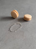 Sterling silver linked hearts bracelet. The bracelet is shown in front of two Ladurée macaroons.