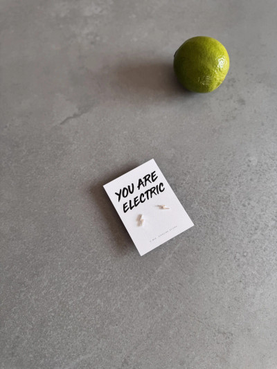 Sterling silver lightning bolt earrings on a 'You Are Electric' message card.