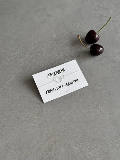 Sterling silver linked rings bracelet on a 'Friends Forever' message card. The bracelet is shown next to some cherries. Sterling silver linked rings bracelet on a 'Friends Forever' message card. The bracelet is shown next to some cherries.