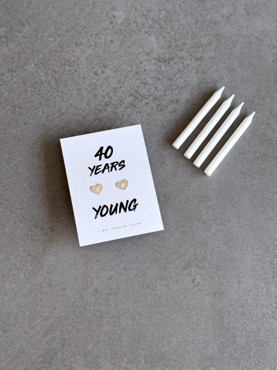 Sterling silver engraved heart earrings on a '40 Years Young' message card. The earrings are shown next to four candles to symbolise 4 decades for a 40th birthday.