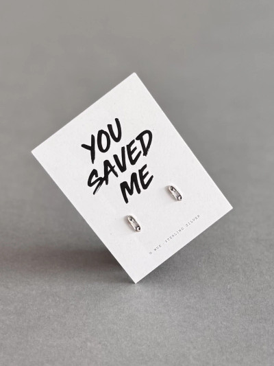 Sterling silver safety pin earrings on a 'You Saved Me' message card. Sterling silver safety pin earrings on a 'You Saved Me' message card.