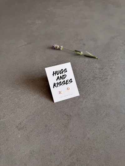 Sterling silver XO earrings presented on a 'Hugs And Kisses' message card. Sterling silver XO earrings presented on a 'Hugs And Kisses' message card.