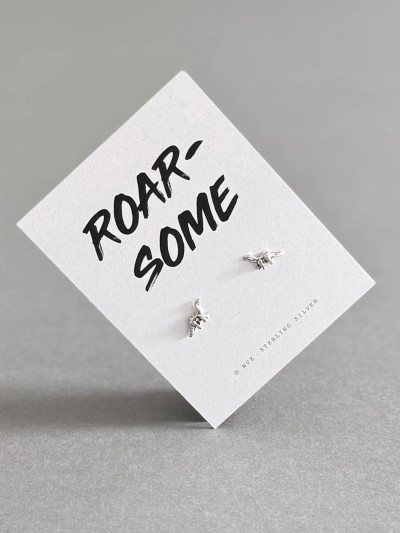 Sterling silver dinosaur earrings on a 'Roar-some' message card. Sterling silver dinosaur earrings on a 'Roar-some' message card.