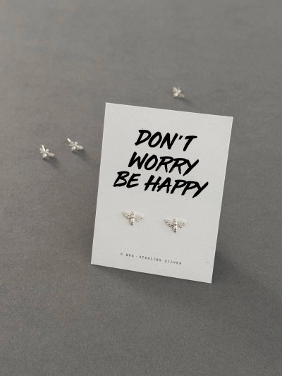 Sterling silver bee earrings on a 'Be Happy' message card. The earrings are also shown loose behind the message card.