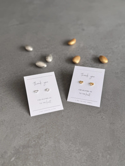 Sterling silver and 18k gold vermeil heart knot earrings on a 'Thank You For Helping Us Tie The Knot' message card. Sterling silver and 18k gold vermeil heart knot earrings on a 'Thank You For Helping Us Tie The Knot' message card.