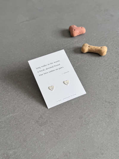 Sterling silver paw heart earrings on a Haiku poem message card. Sterling silver paw heart earrings on a Haiku poem message card.