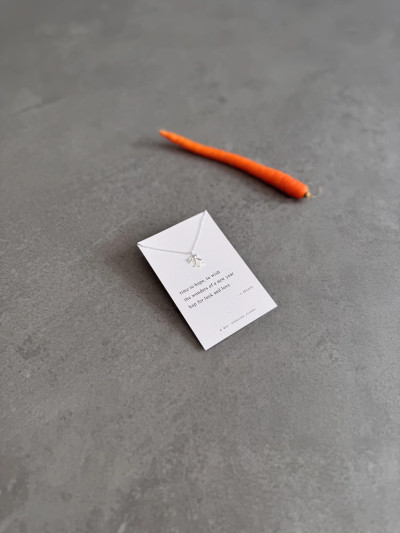 Sterling silver origami style bunny necklace on an Easter Haiku poem message card. Sterling silver origami style bunny necklace on an Easter Haiku poem message card.