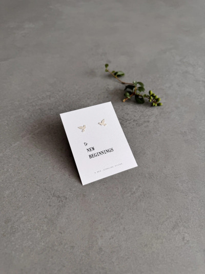 Sterling silver dove earrings on a 'New Beginnings' message card. Sterling silver dove earrings on a 'New Beginnings' message card.