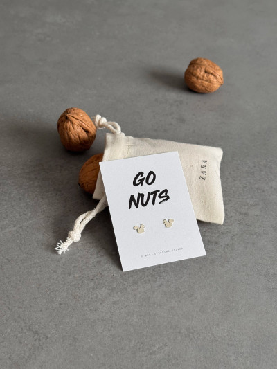 Sterling silver squirrel earrings on a 'Go Nuts' message card. The earrings are shown with their cotton gift bag surrounded by walnuts.