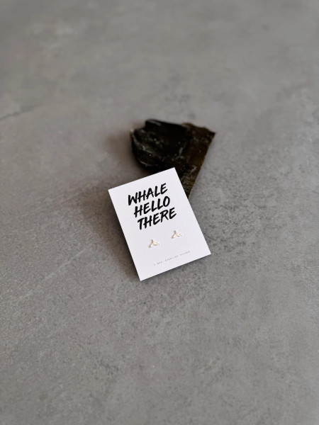 Sterling silver whale tail earrings on a 'Whale Hello There' message card.