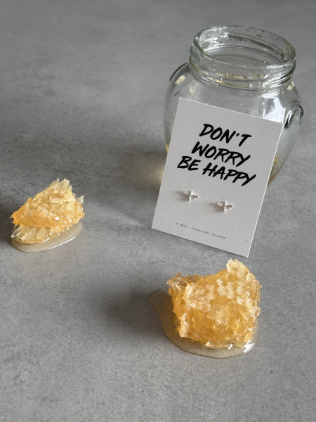 Sterling silver bee earrings on a 'Don't Worry Be Happy' message card.
